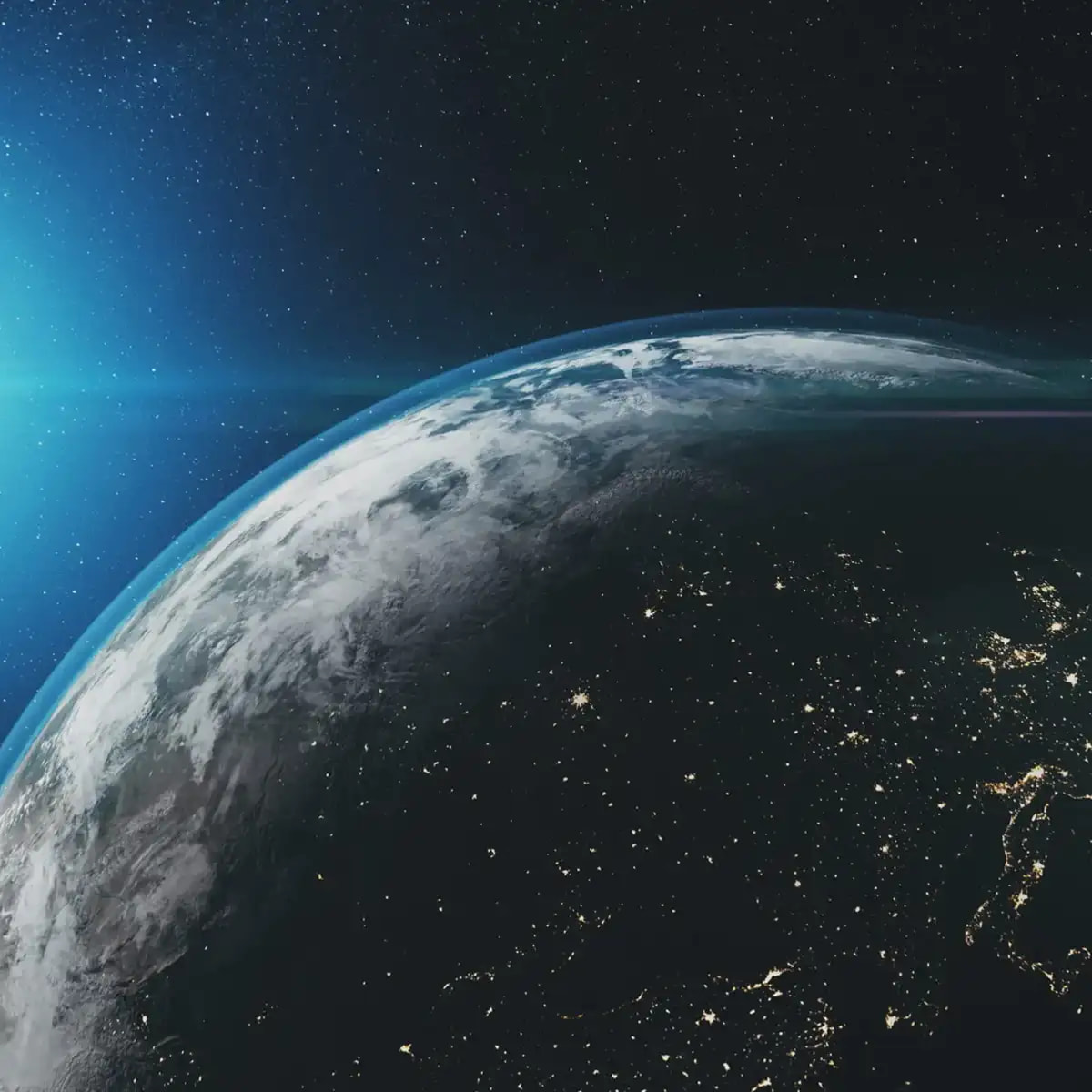 View of Earth from space with sunlight illuminating the planet’s horizon.