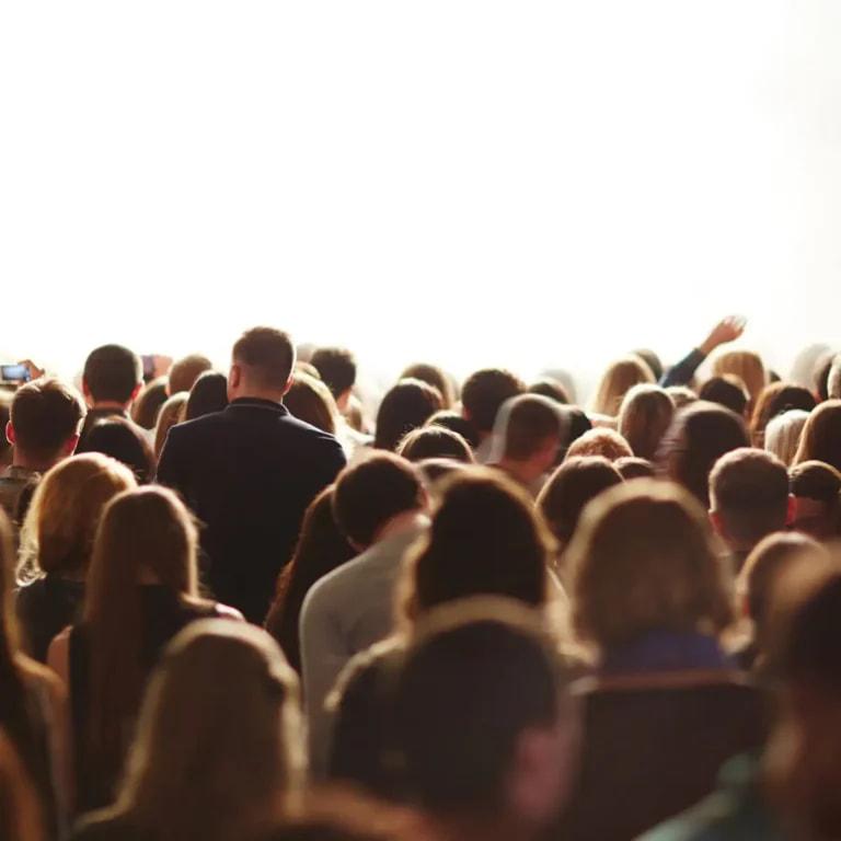 Crowd of people gathered together at an event.